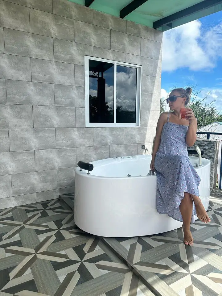 Private rooftop terrace with a round jacuzzi and lounge seating at Koimala Maamigili