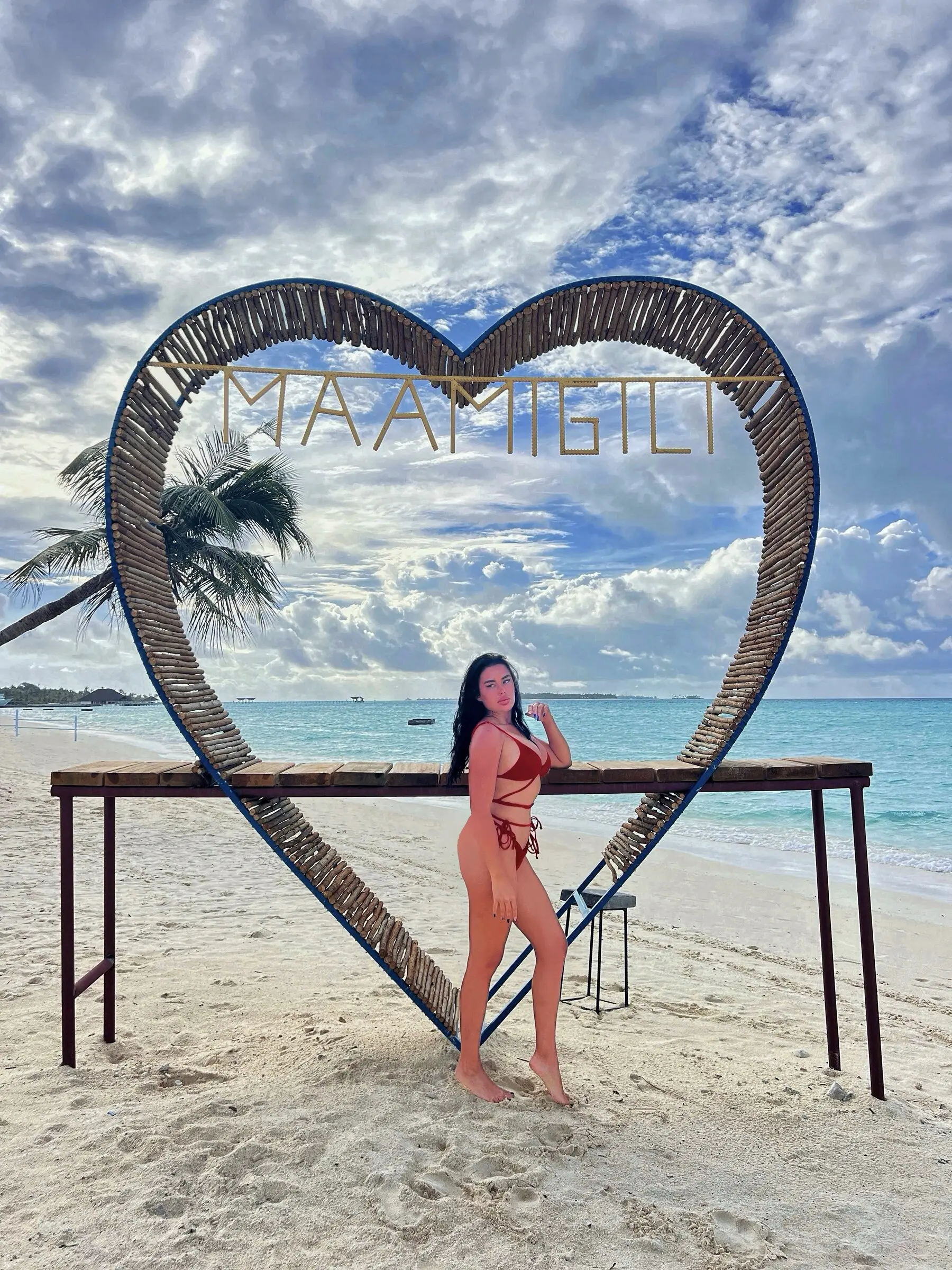 Guest at the Maamigili heart swing on the beach