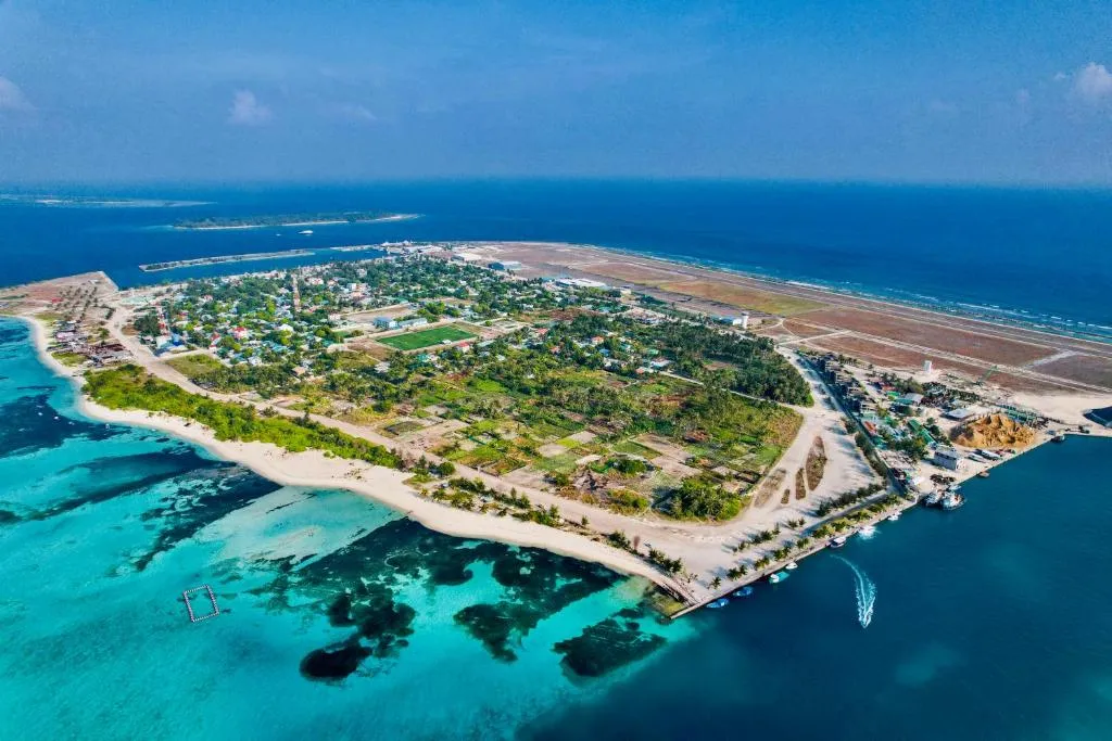 Aerial view of Maamigili island and its airport runway, South Ari Atoll